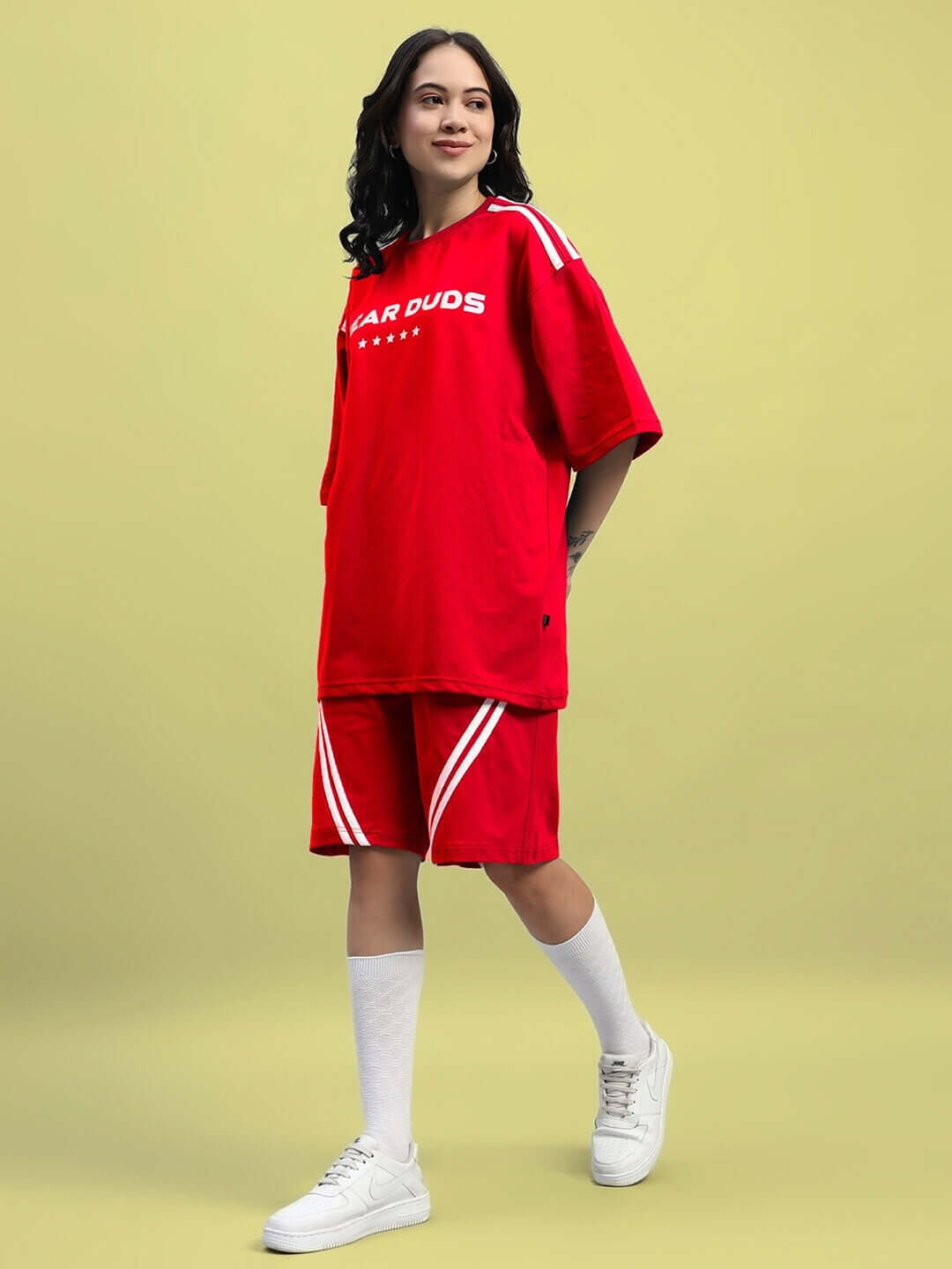 Woman wearing a red Women's Star Jumper Summer Co-ord Set made from premium cotton French terry. Fashionable and comfortable ensemble.