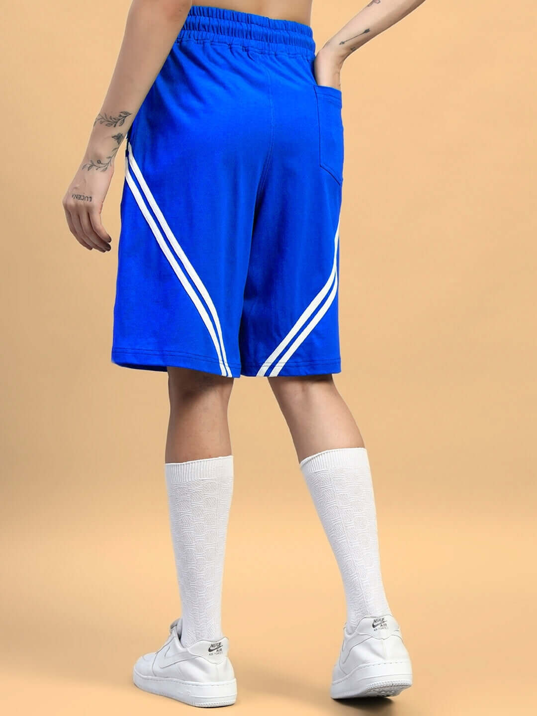 Back view of WOMENS STAR JUMPER SUMMER CO-ORD SET BLUE shorts with white stripes, highlighting streetwear style.