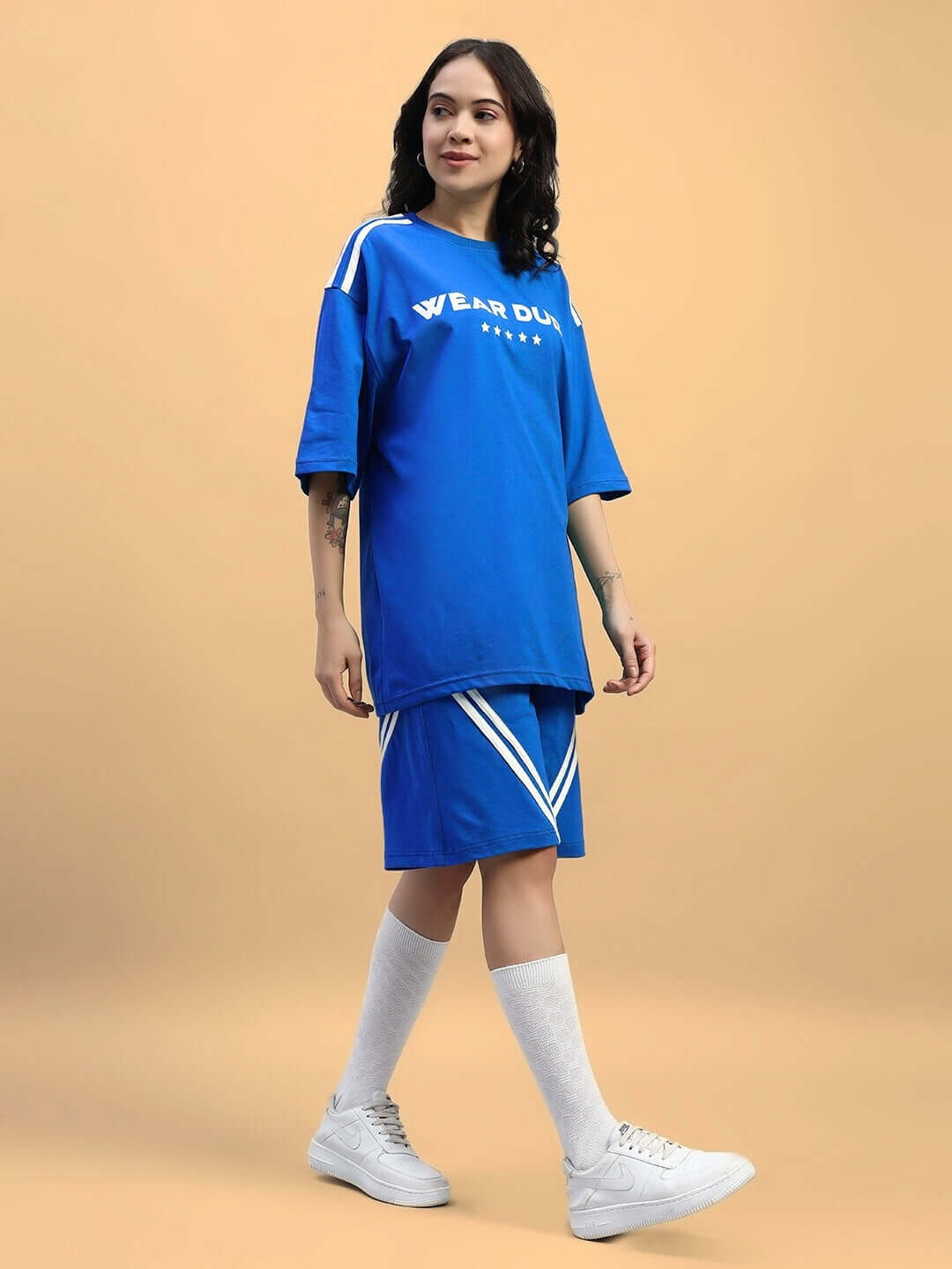 Model wearing Womens Star Jumper Summer Co-Ord Set Blue, featuring an oversized t-shirt and shorts in breathable lightweight cotton.