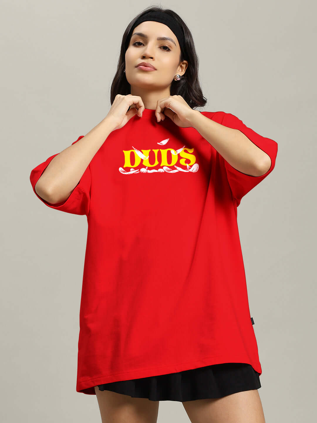 Woman wearing a red oversized t-shirt with yellow 'DUOS' print, crafted from premium heavy gauge 97% cotton French terry.