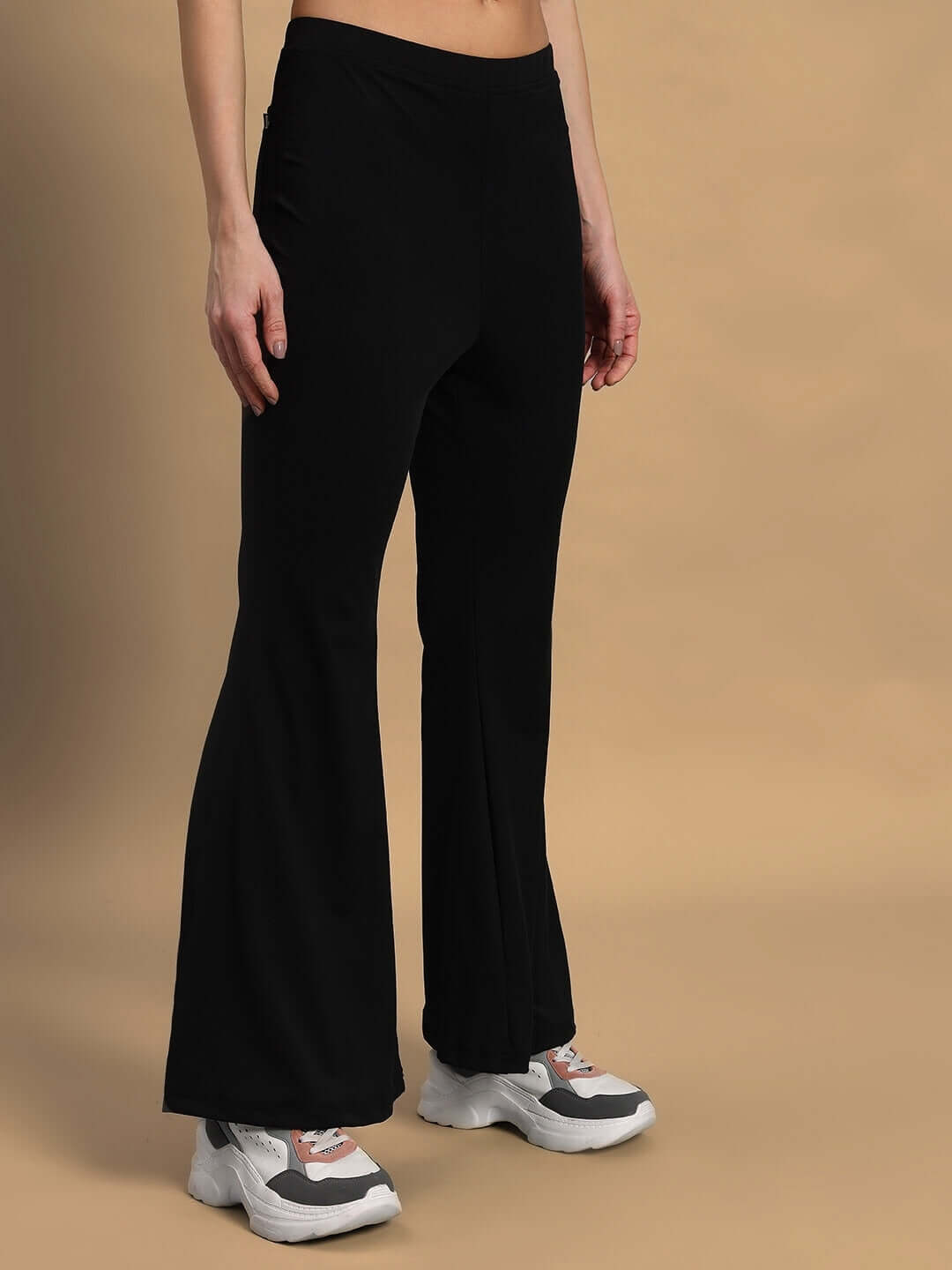 Women's Stella Boot Cut Pant in black, showcased on a model with casual sneakers; a stylish and bespoke fit by DUDS Tailors.