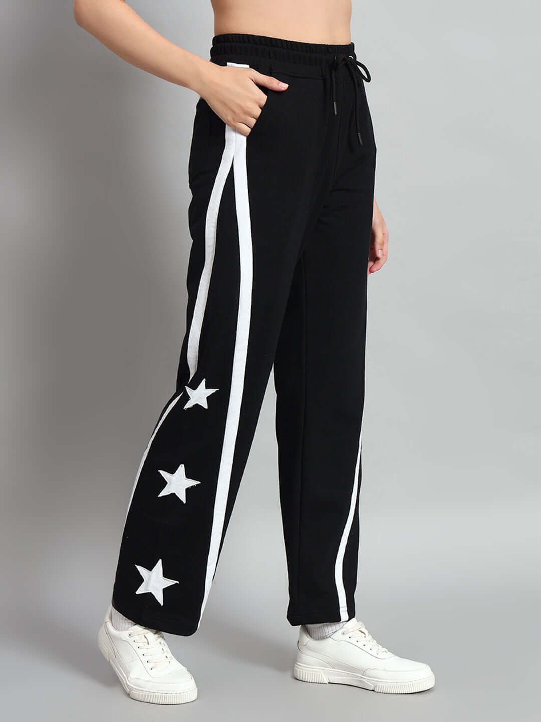Women's black joggers with star patterns, relaxed fit, and customizable size options from DUDS, made by experienced tailors.