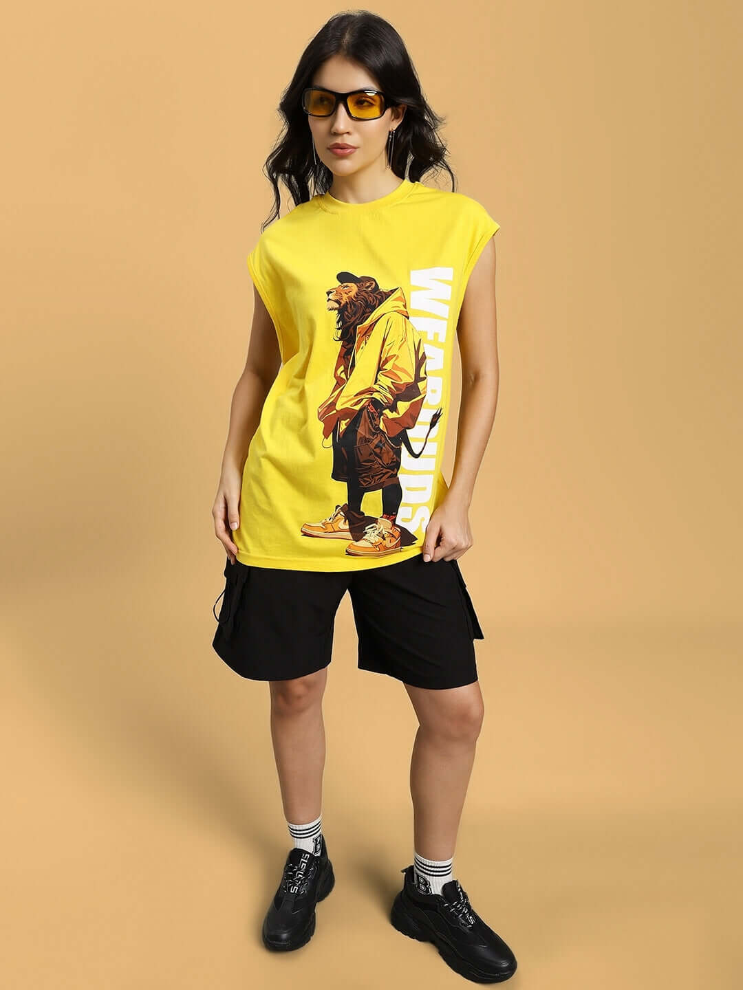 Woman wearing a yellow Women's Street Lion Gym T-Shirt with a graphic print, showcasing a stylish casual look.