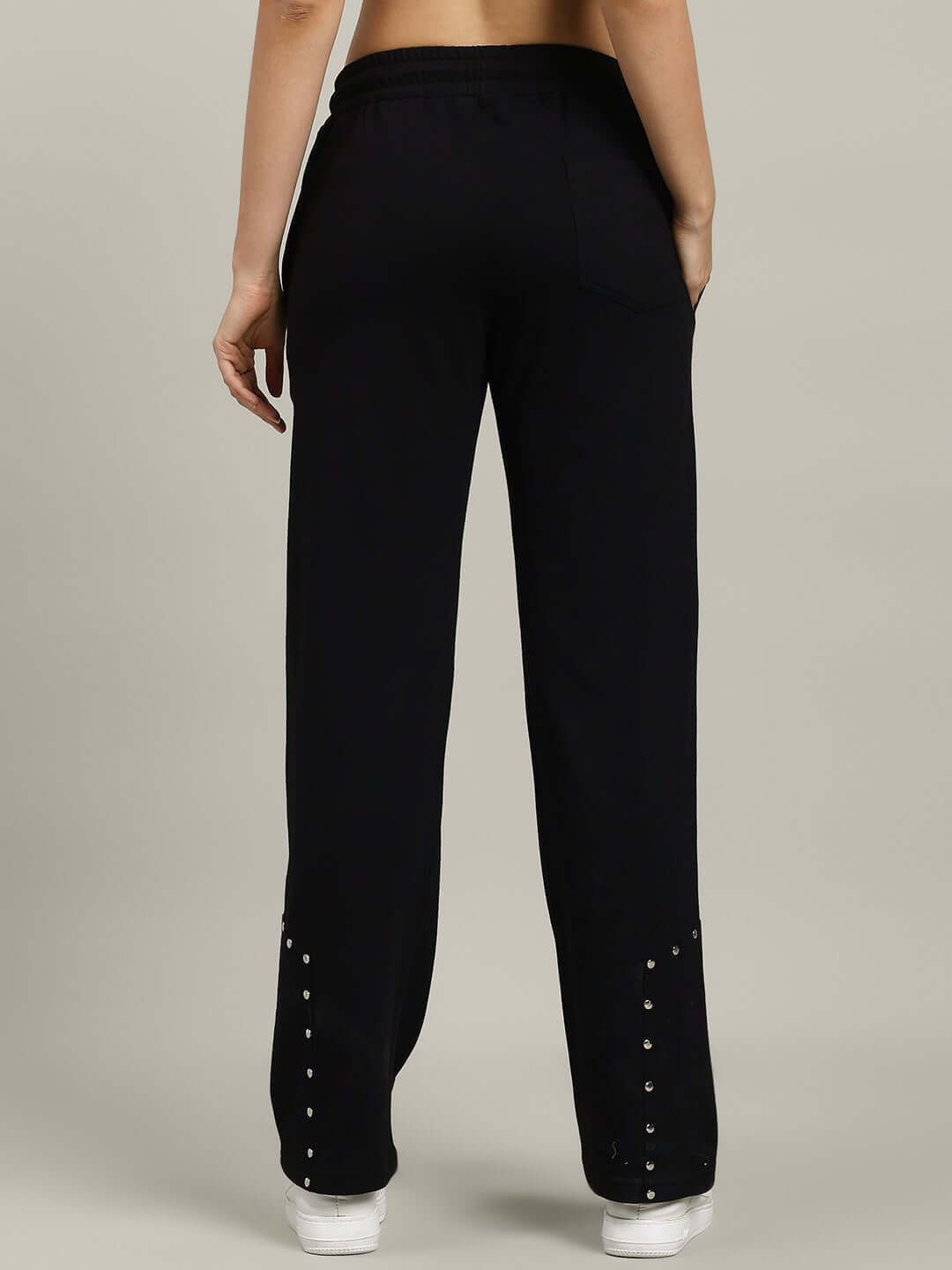 Back view of WOMEN'S STUNNER RELAXED FIT JOGGER BLACK, showcasing studded detailing and relaxed fit for comfort and style.