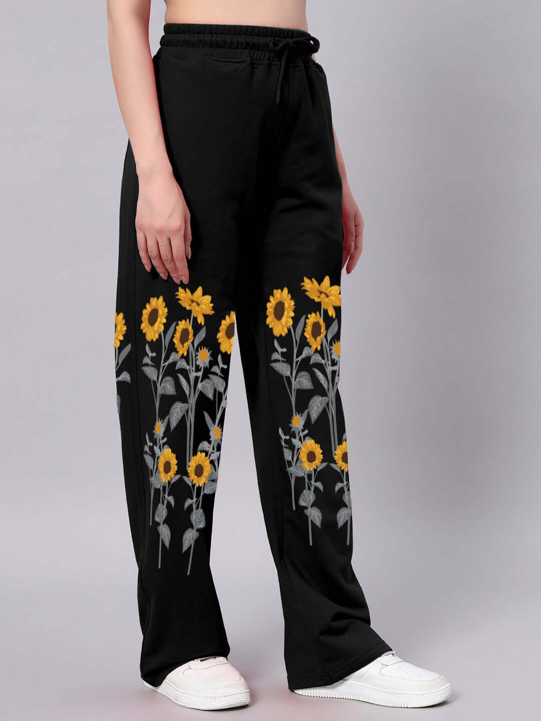 Women's black jogger pants with sunflower print, relaxed fit, customizable size options, made-to-order by DUDS tailors, stylish and comfortable.