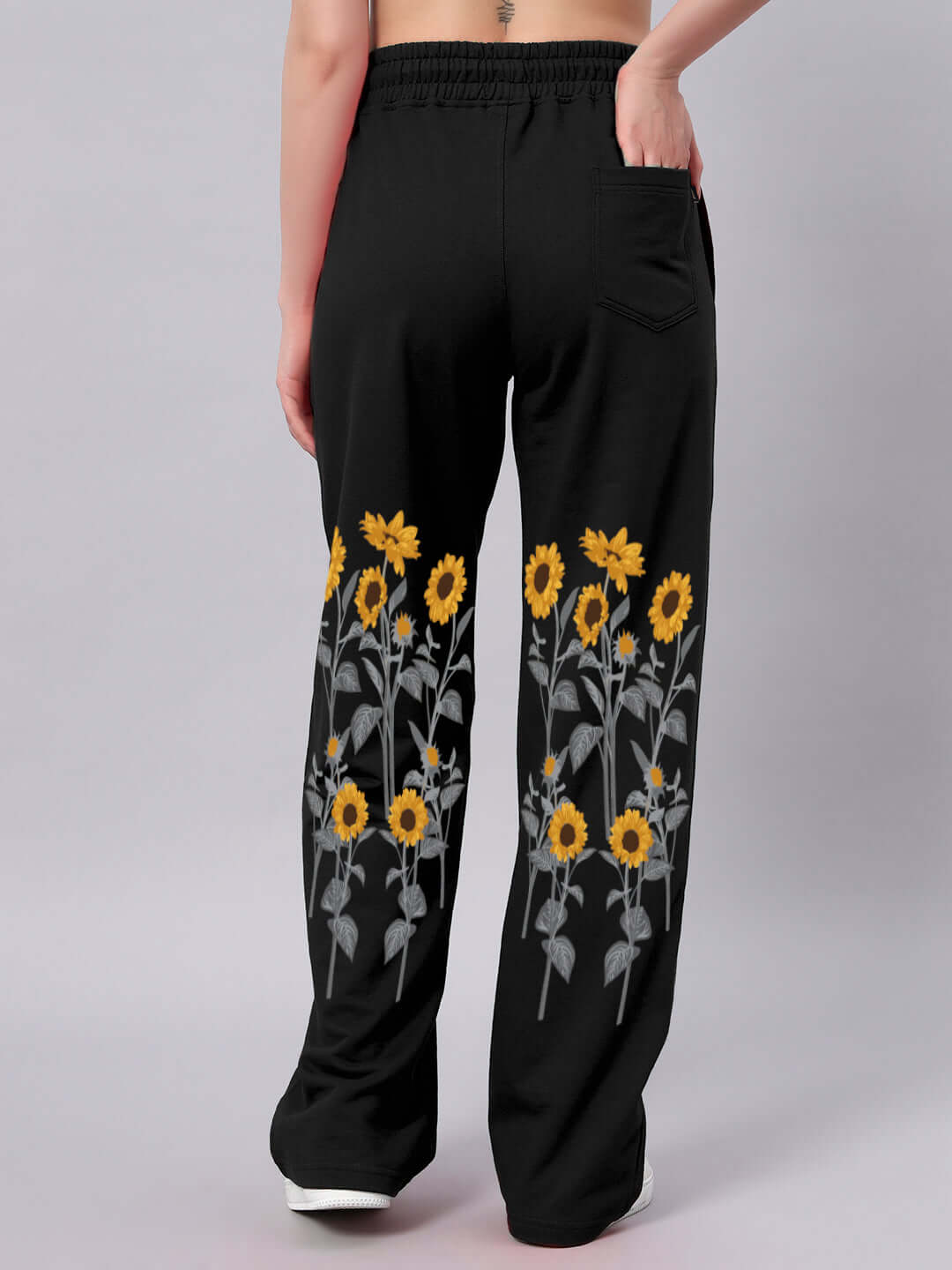 Back view of black women's joggers with sunflower print design, highlighting the relaxed-fit style and comfortable waistband.