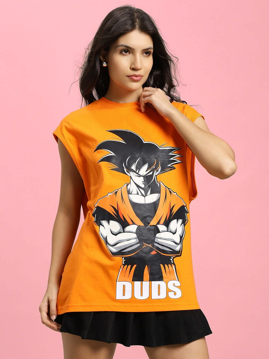 Women's Super Saiyan gym t-shirt in orange featuring anime graphic, model wearing DUDS design on pink background.