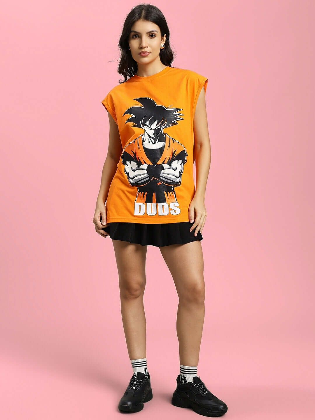Woman wearing an orange Super Saiyan gym t-shirt with bold anime design and 'DUDS' print, suitable for custom fit orders.