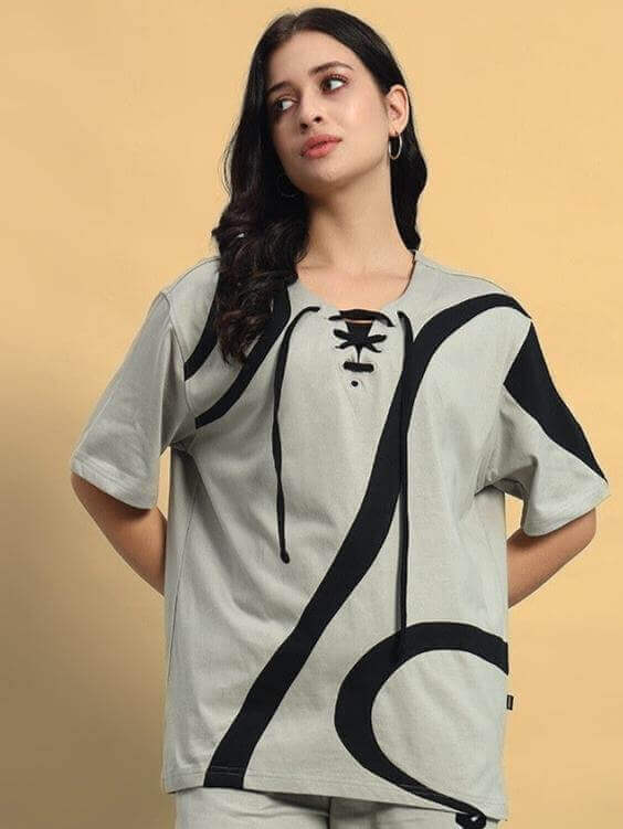 Model wearing women's oversized grey surfing t-shirt with black abstract design, made from premium cotton blend fabric. Country of origin: India.