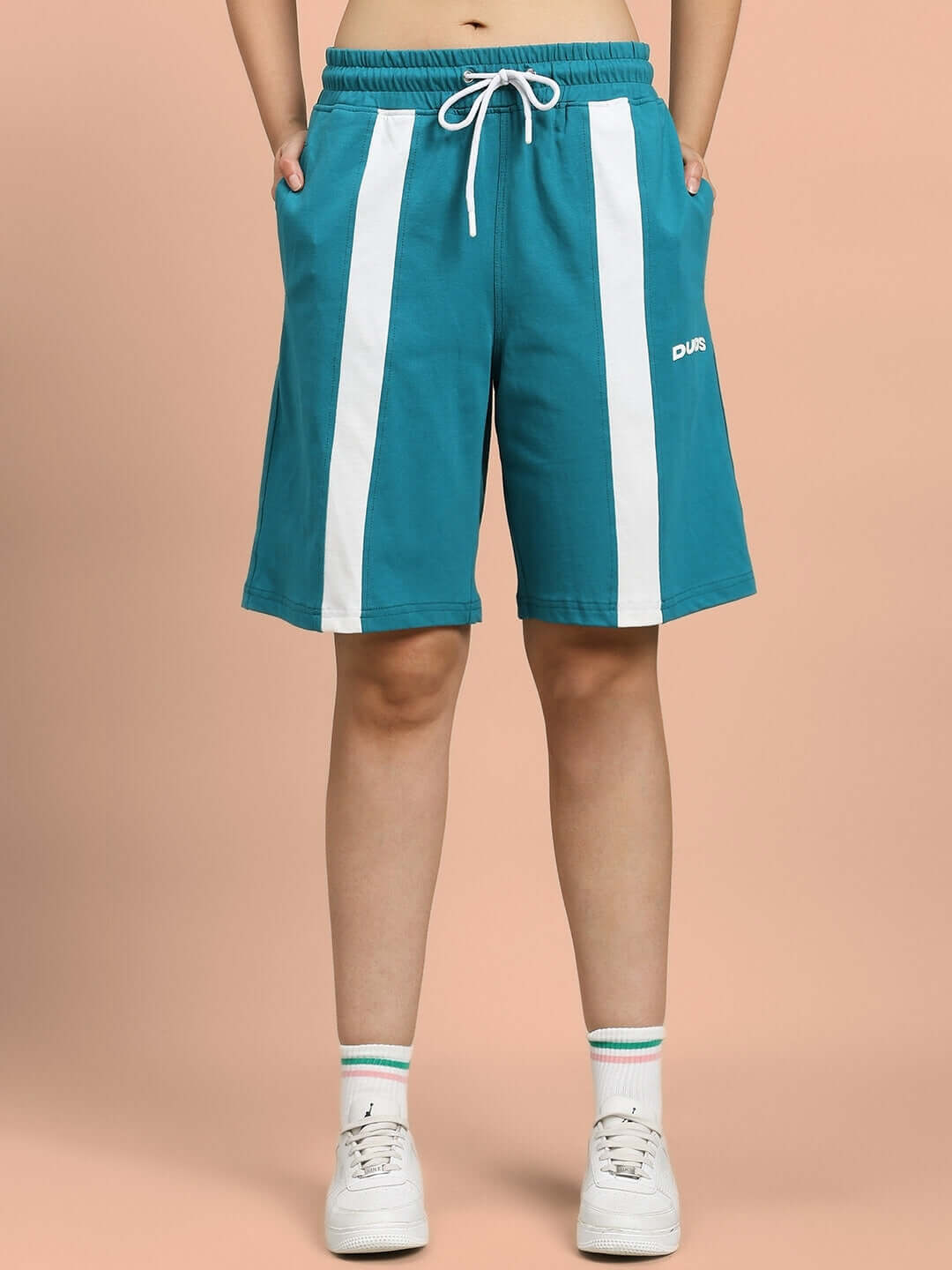 Model wearing WOMEN'S WIDELINE SUMMER CO-ORD SET TEAL shorts with white stripes.