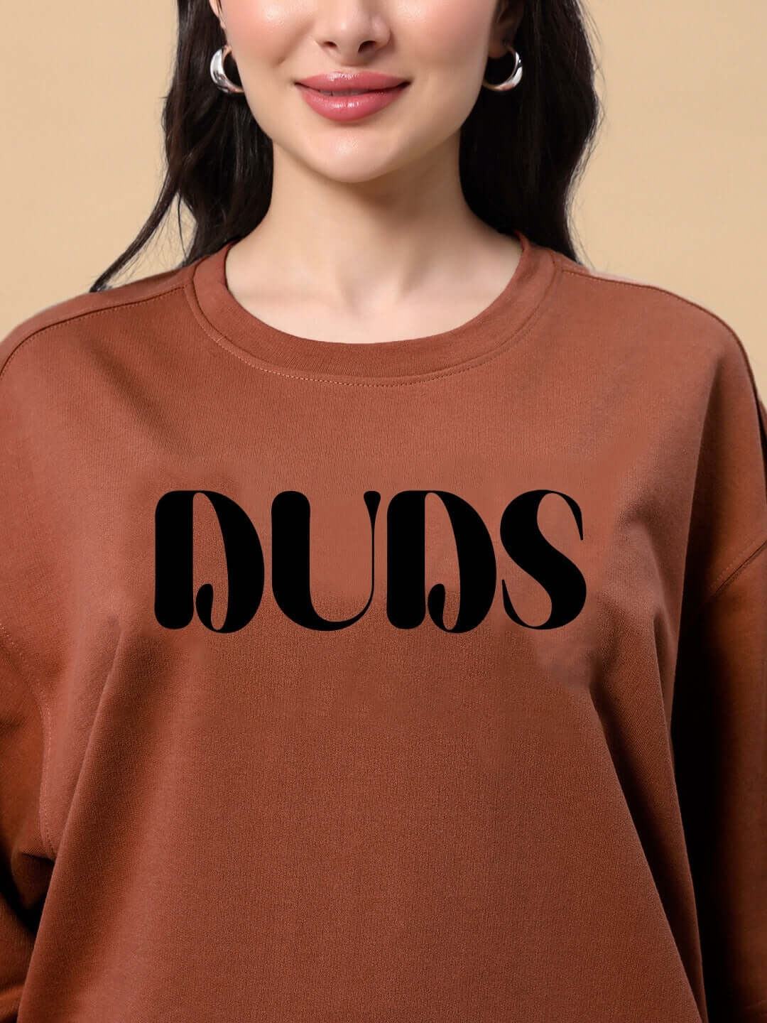 Model wearing Women's Teddy Bean T-Shirt in brown with bold text design, made from premium cotton French terry, by Color By Colours.
