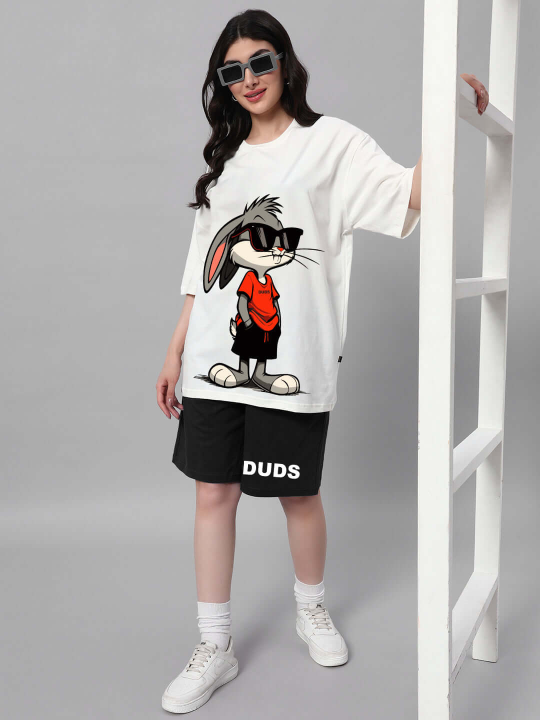 Model wearing Women's Think Big Bunny Toons Co-ord Set in off-white and black, featuring a cartoon character print, casual and stylish outfit.