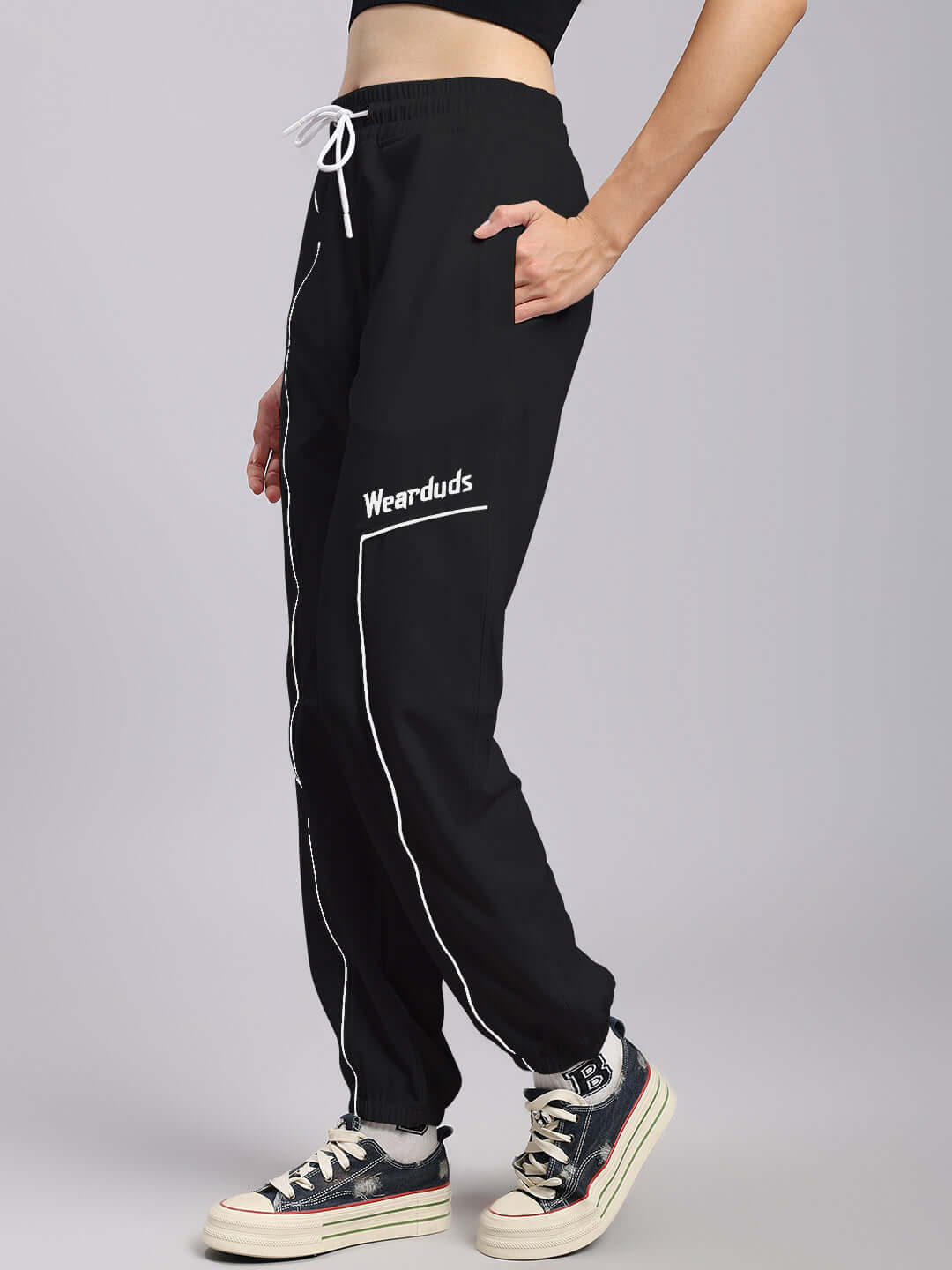 Side view of Women's Tokyo Relaxed Fit Joggers in black, featuring a white drawstring and side pockets, made by DUDS.