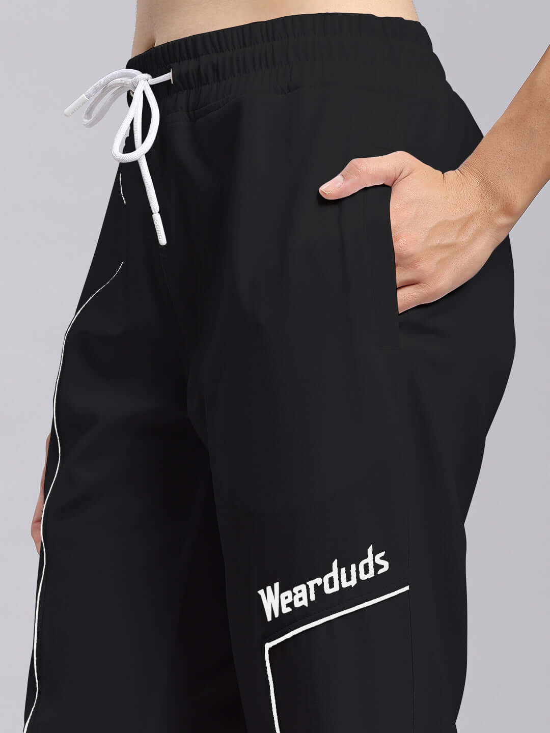 Close-up of black women's relaxed fit joggers from DUDS featuring a drawstring waist and side pocket, designed for comfort and style.