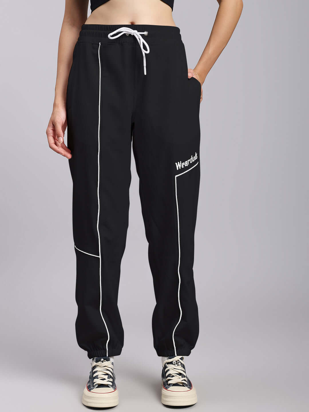 Women's black relaxed fit joggers with white drawstring, designed for comfort by experienced tailors at DUDS.