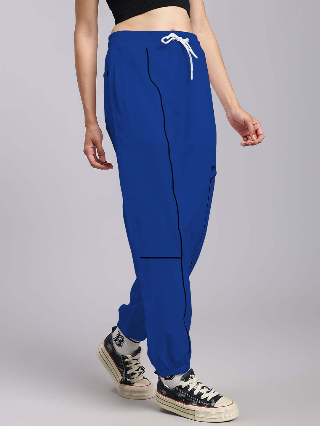 Woman wearing blue Tokyo relaxed fit joggers with sneakers, showcasing comfortable and stylish casual wear for women.