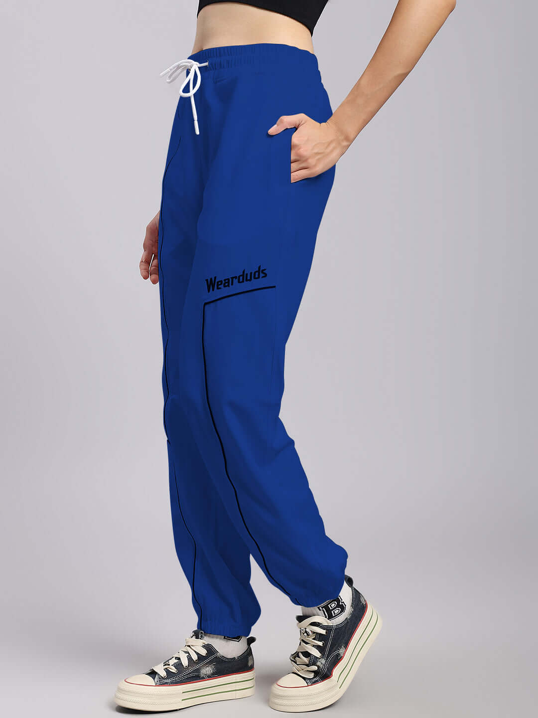 Women's Tokyo relaxed fit blue joggers by DUDS, side view with white drawstring and custom fit option, paired with casual sneakers.
