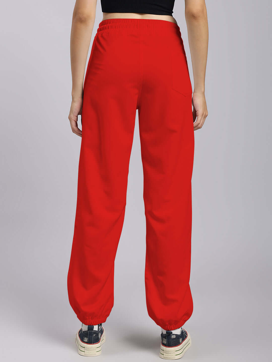 Women's red relaxed fit joggers from DUDS, back view, showcasing comfortable tailoring with elastic waistband and cuffs.