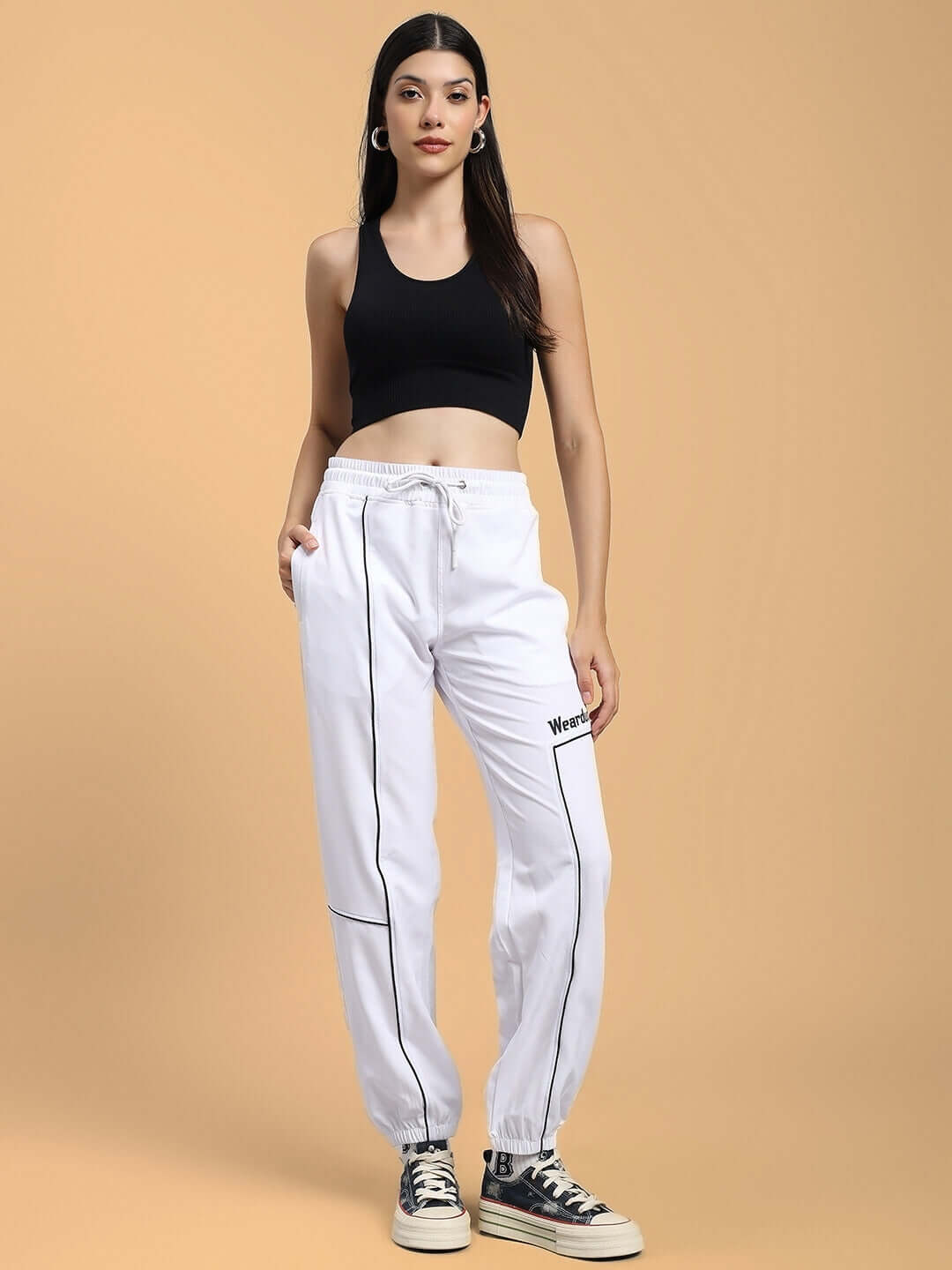 WOMENS TOKYO RELAXED FIT JOGGERS WHITE modeled with black crop top for stylish casual look