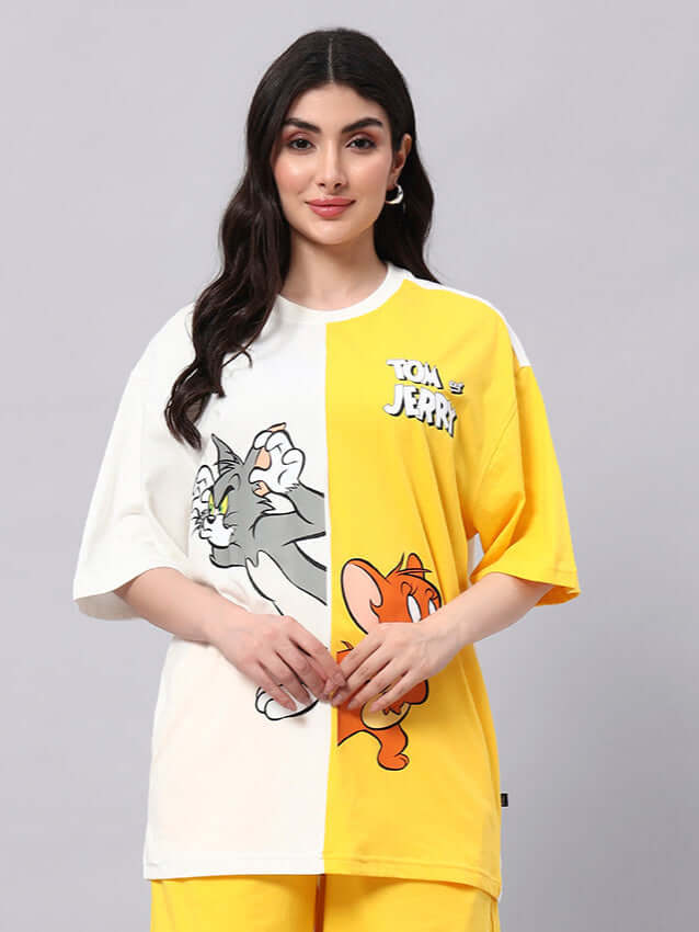 Model wearing women's off-white yellow Tom & Jerry oversized t-shirt, perfect for trendy summer looks, made of lightweight cotton.