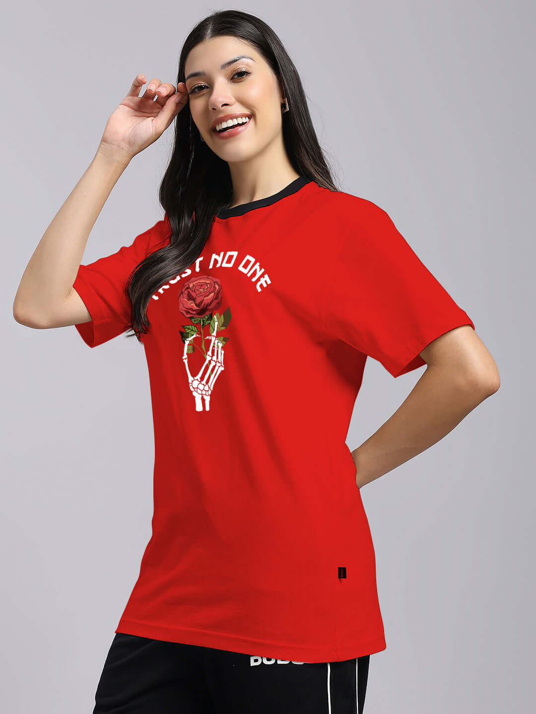 Woman wearing a red 'Trust No One' printed T-shirt with a rose design, made of premium 100% Cotton, showcasing casual style and comfort.