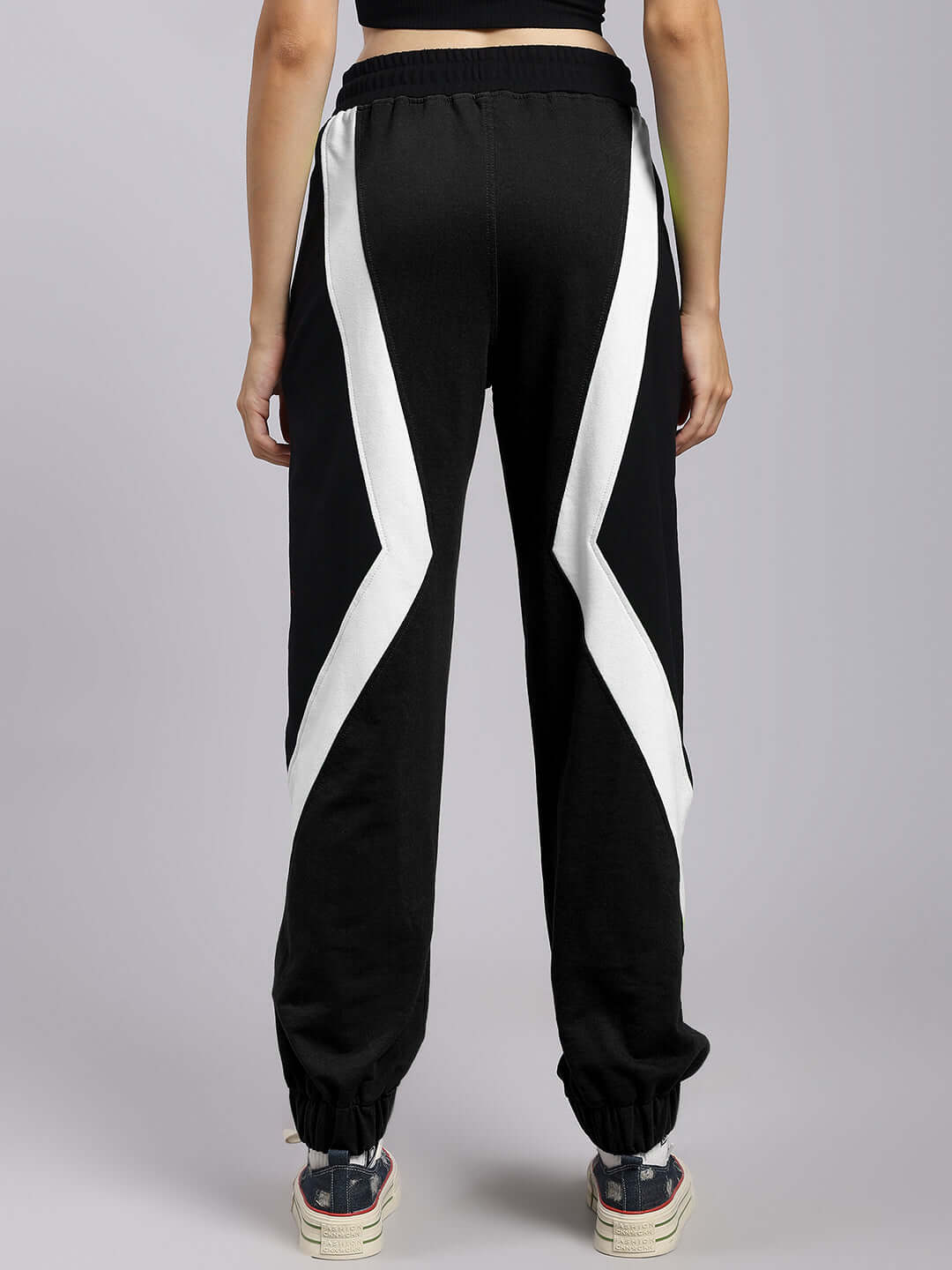 Back view of Women's Ultra Colorblock Relaxed-Fit Joggers in Black and White, featuring a bold zigzag pattern design and elastic cuffs.
