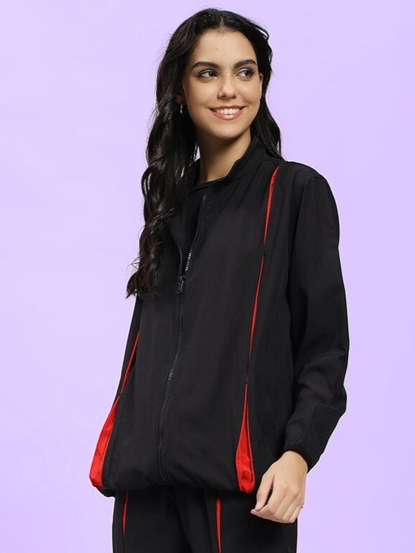 WOMEN UNISON RELAXED FIT JACKET BLACK RED on model, showcasing street-style fashion with black and red contrast.