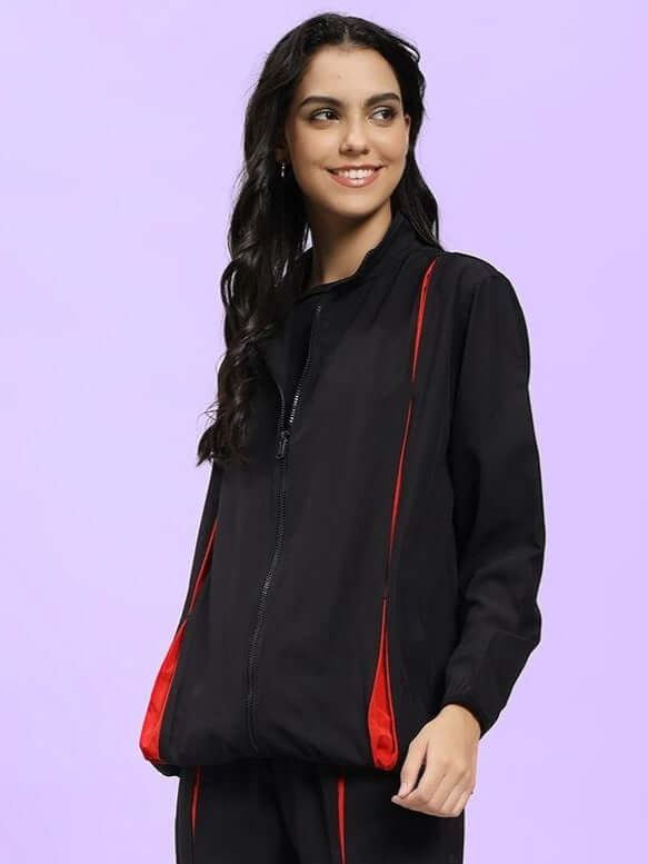 WOMEN UNISON RELAXED FIT JACKET BLACK RED on model, showcasing street-style fashion with black and red contrast.