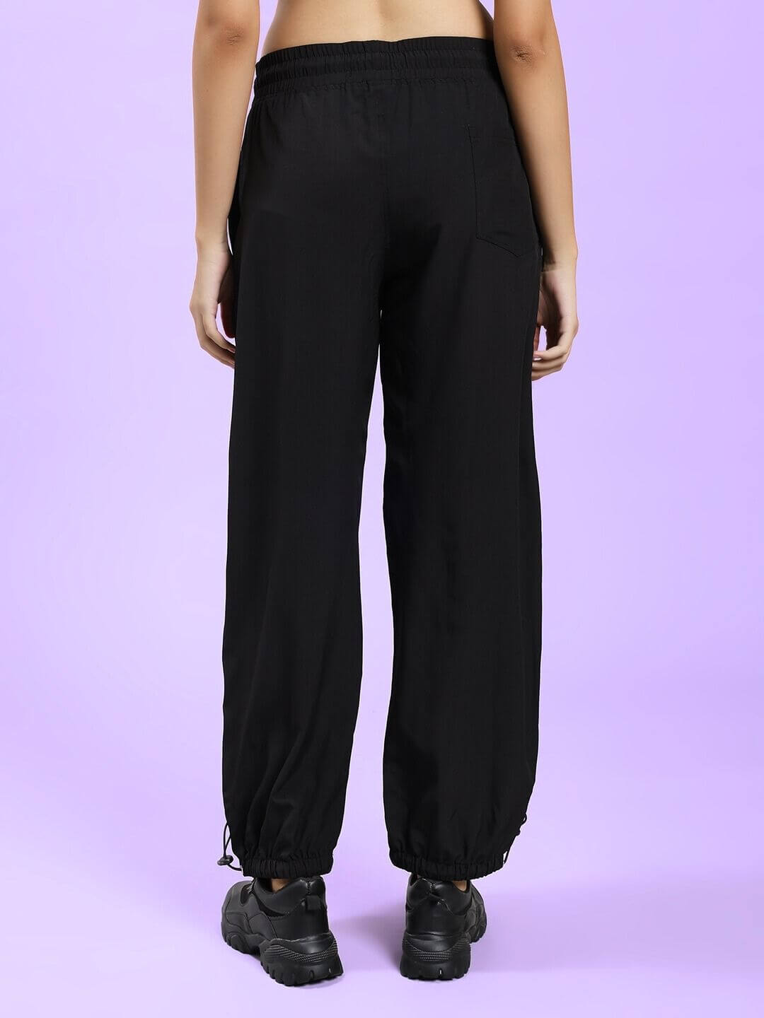 Back view of WOMEN UNISON RELAXED-FIT JOGGERS BLACK RED on model