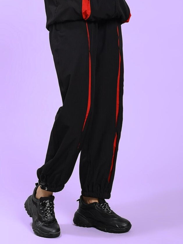 Model wearing Women's Unison Relaxed-Fit Joggers Black Red showcasing style and comfort with red accents and black joggers.