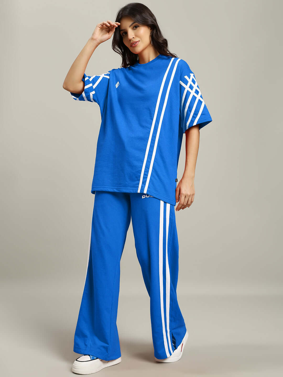 Model wearing Women's United Stripe Co-Ord Set in blue with white stripes, made from premium cotton French terry lycra, comfortable fit.