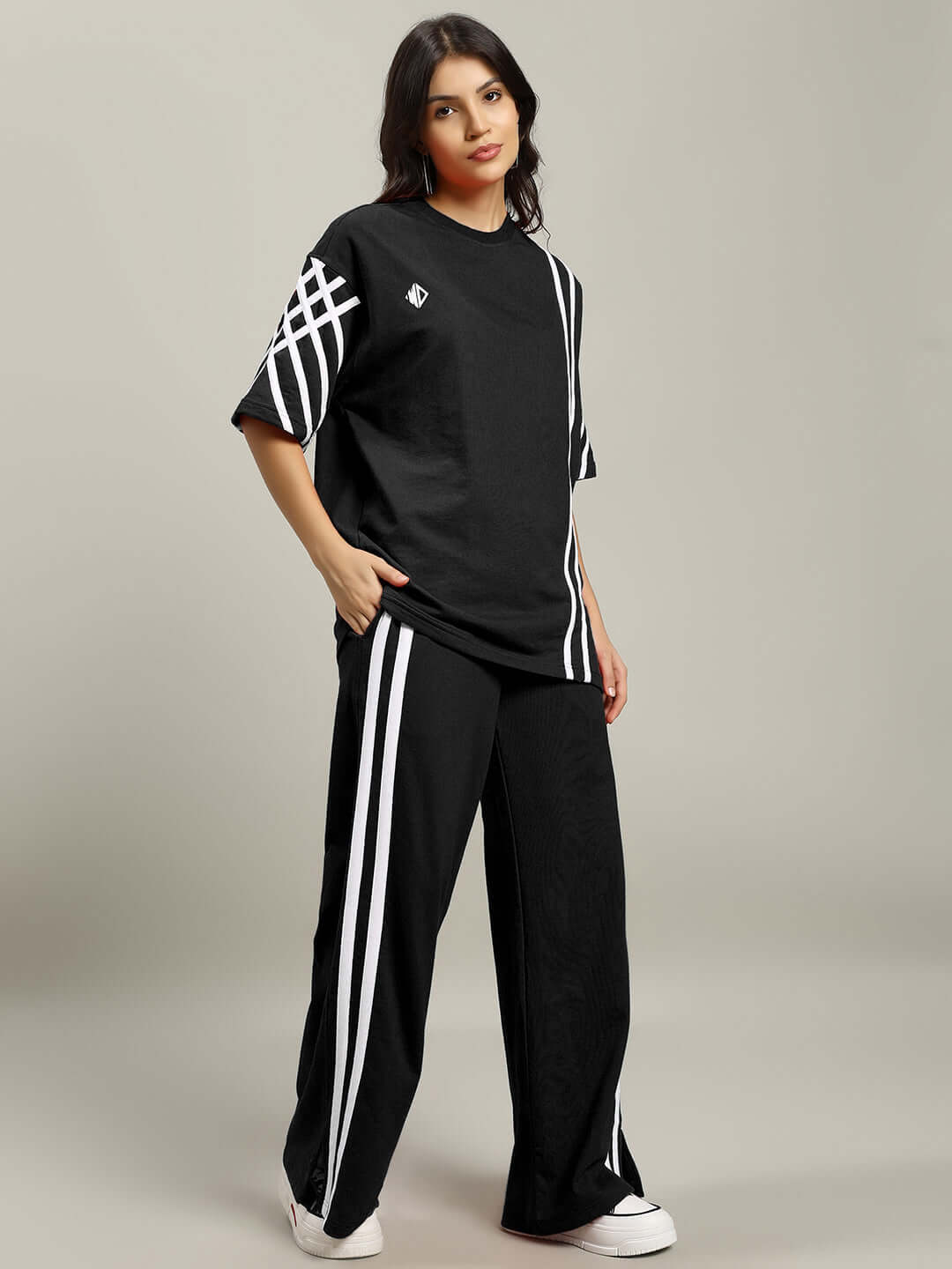 Woman wearing black United Stripe Co-Ord Set with white stripes, made of premium cotton blend fabric, styled for casual comfort.