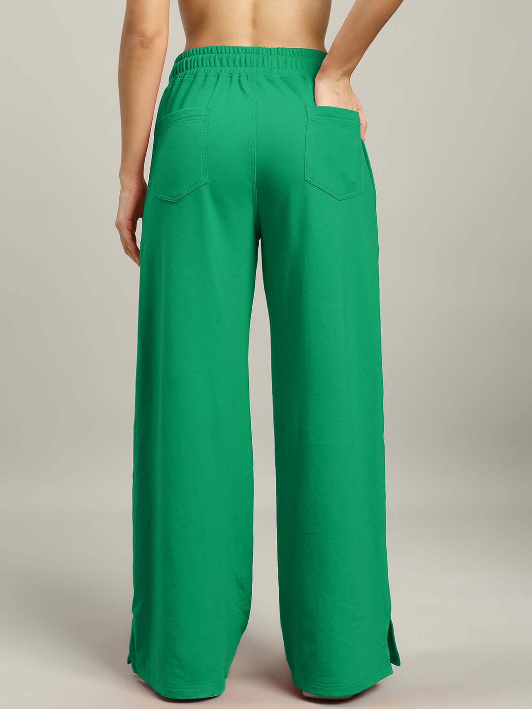 Back view of green women's stripe co-ord set pants, premium heavy gauge fabric, featuring elastic waistband and back pockets.