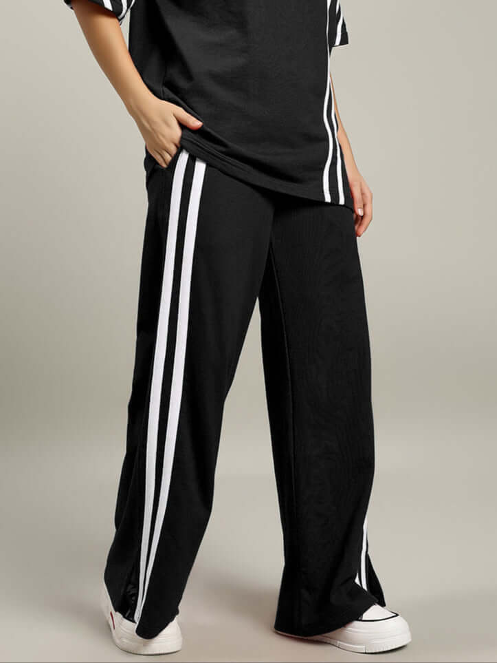 Black women's stripe joggers by DUDS, designed for comfort and style, customizable fit available, experienced tailor craftsmanship.