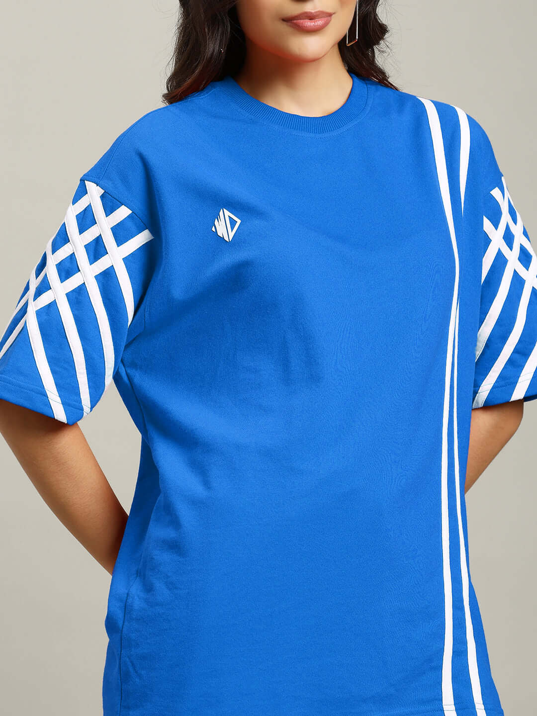 Women's blue oversized T-shirt with white stripes, made from premium cotton blend, showcasing a relaxed fit.