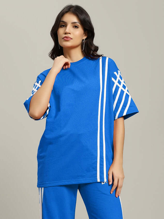 Model wearing blue oversized women's t-shirt with white stripes and matching pants, made from premium cotton French terry.