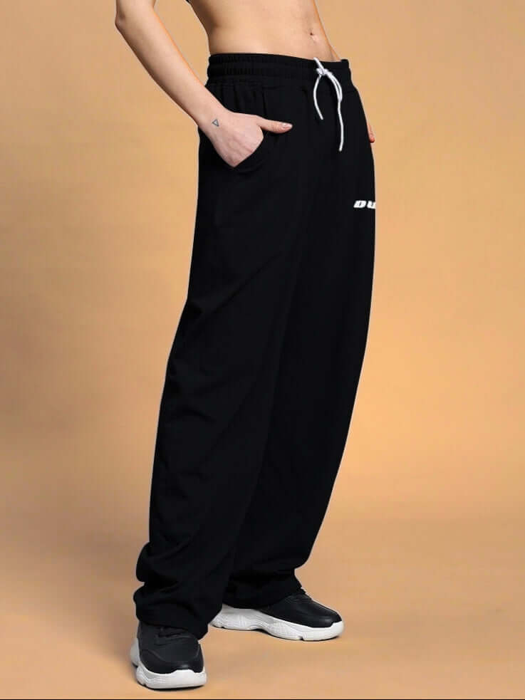 Black women's vanilla relaxed-fit joggers, a made-to-order product by DUDS, worn stylishly with comfortable fit and convenience.