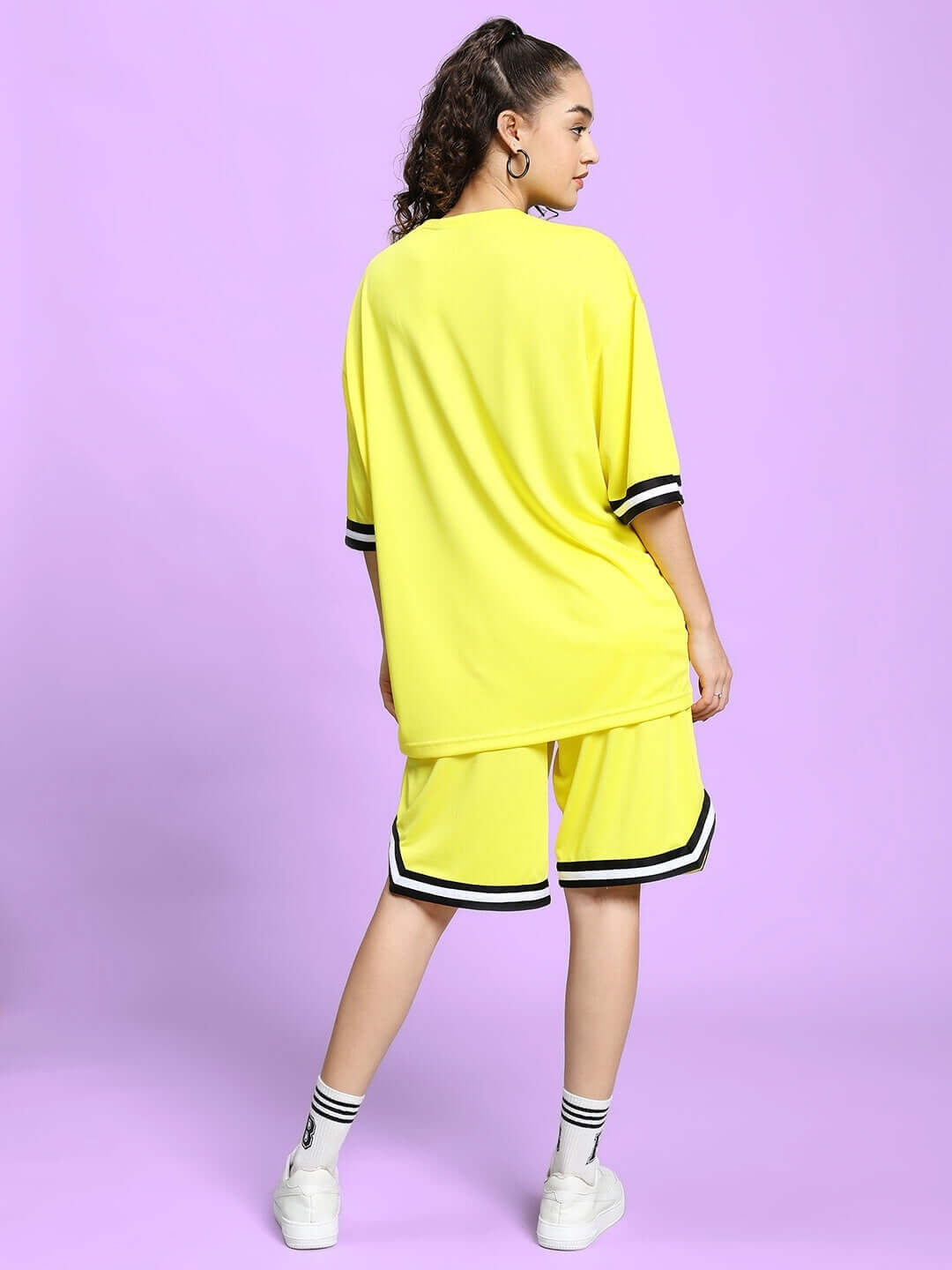 Back view of model wearing WOMEN'S VIGOR COLORBLOCK CO-ORD SET YELLOW, featuring sports polyester fabric, suitable for casual wear.