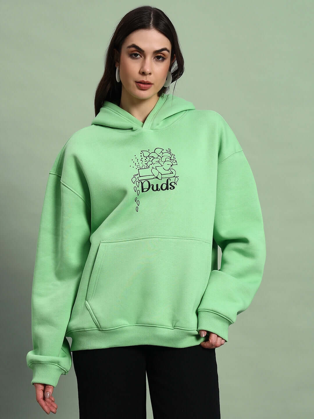 Woman wearing WOMEN VOODO FLEECE OVERSIZED HOODIE GREEN with stylish streetwear look.