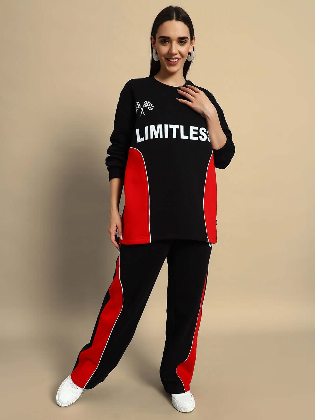 Woman wearing black and red colorblock sweater and cargo pants set, with "LIMITLESS" on the top, exuding bold streetwear style.