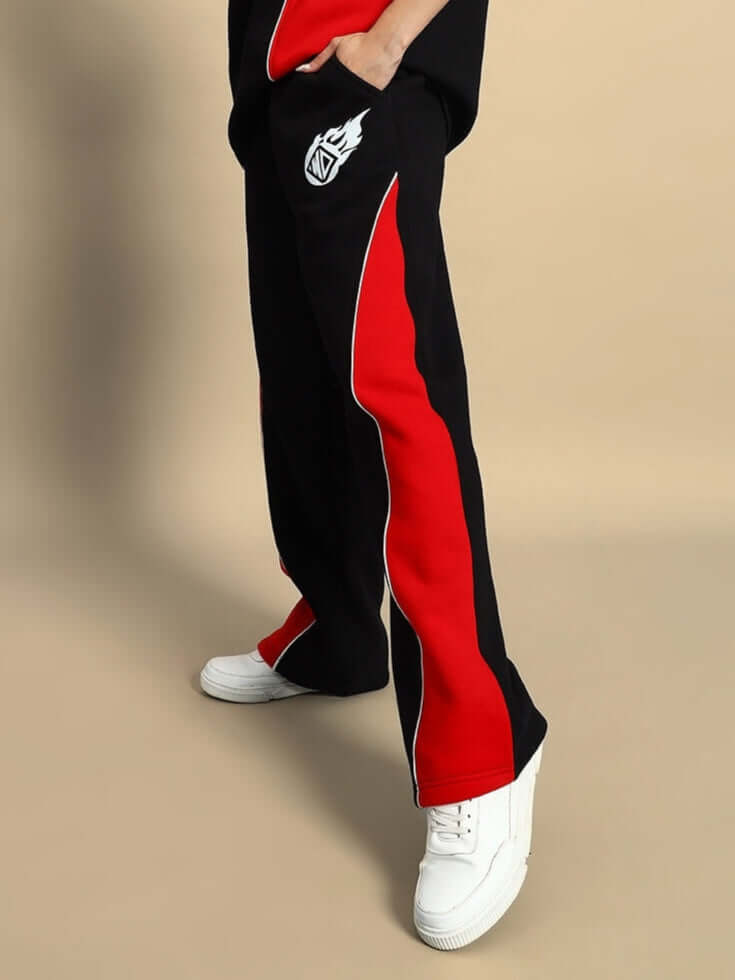 Women's black and red colorblock cargo pants with WD logo, side view showcasing stylish design and white sneakers.