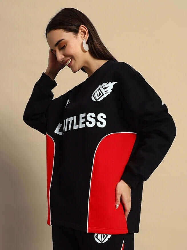 Woman wearing a black and red colorblock co-ord set with "Limitless" text, embodying bold streetwear style and comfort.