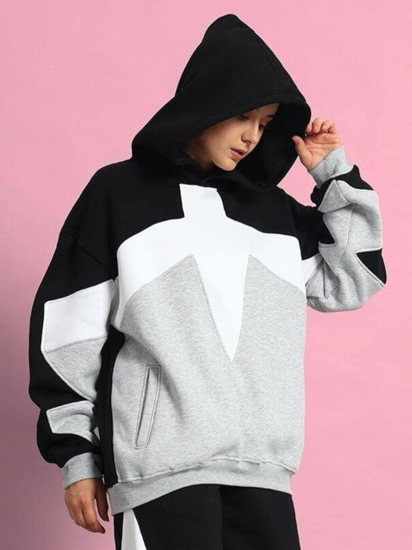 Women wearing a stylish WOMEN WD SWORD FLEECE COLORBLOCK HOODIE BLACK GREY with a modern urban design.