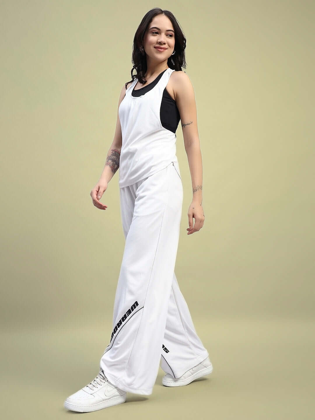 Model wearing WOMEN'S CUBBY CO-ORD SET WHITE, relaxed fit joggers with elasticated waistband, made from premium sports polyester fabric.