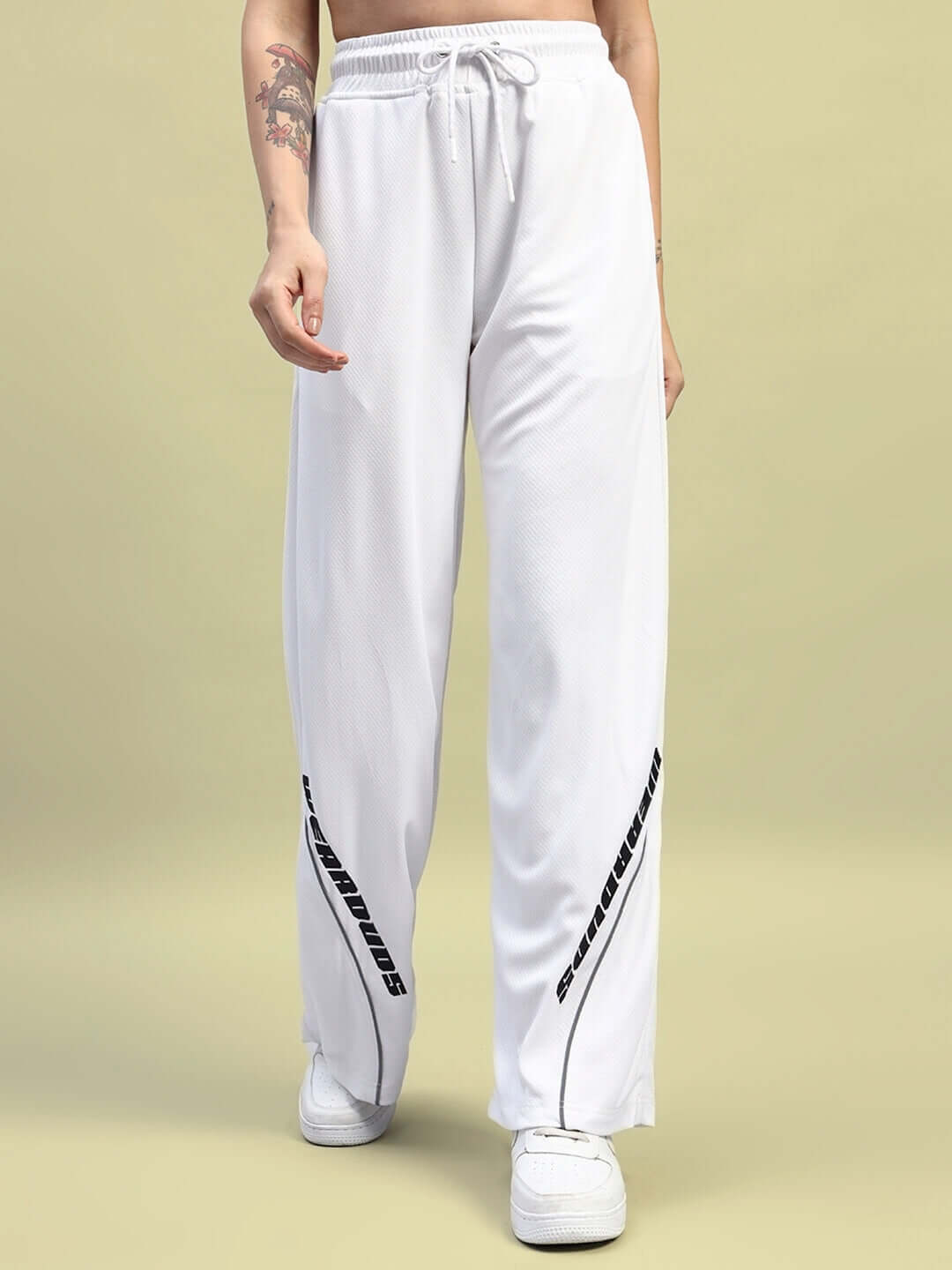 Woman wearing WOMEN'S CUBBY CO-ORD SET WHITE relaxed fit joggers with elasticated waistband and drawstring.
