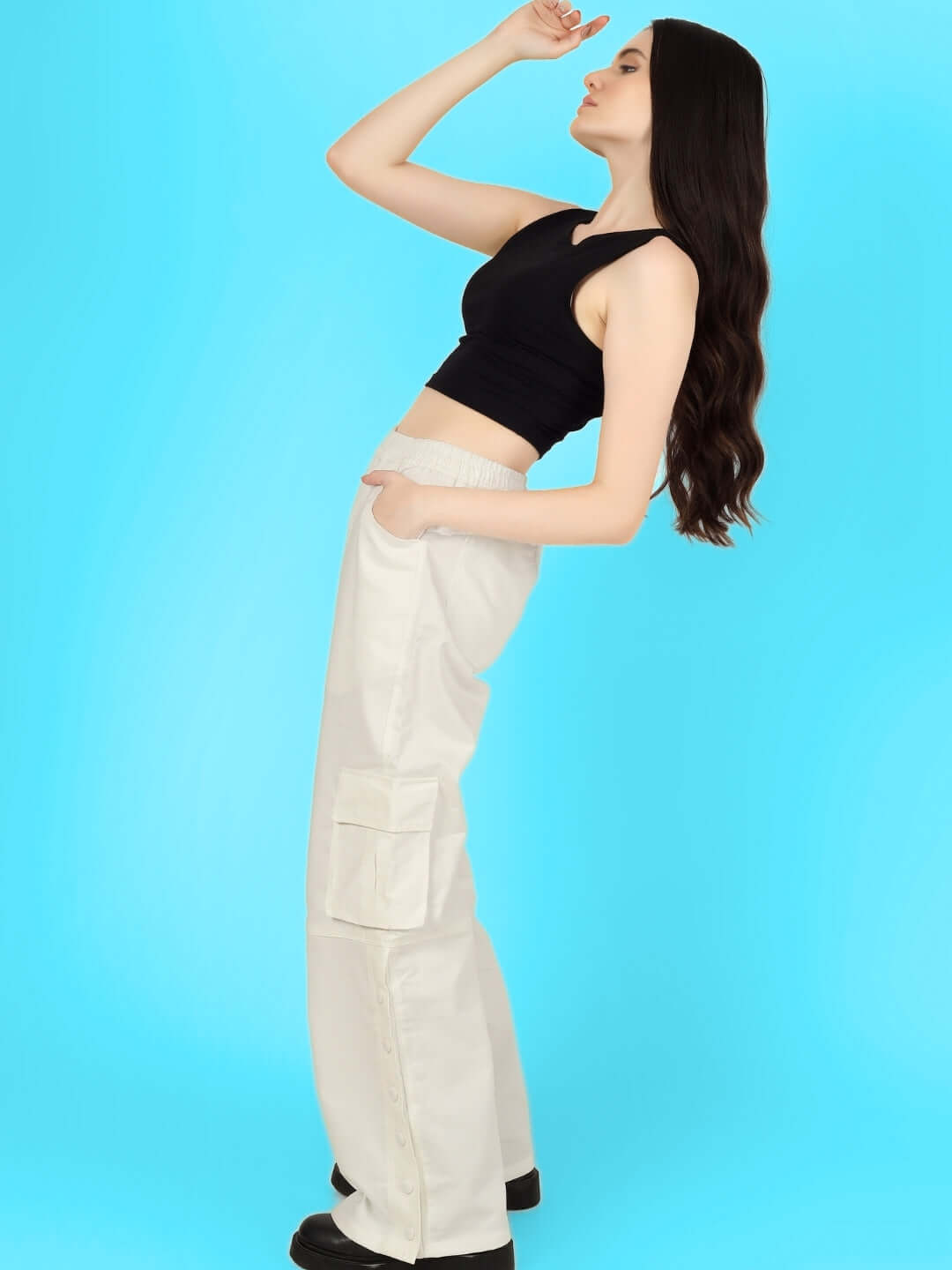 Model wearing women's white side slit button cargo pants with a black crop top, showcasing stylish and versatile fashion options.