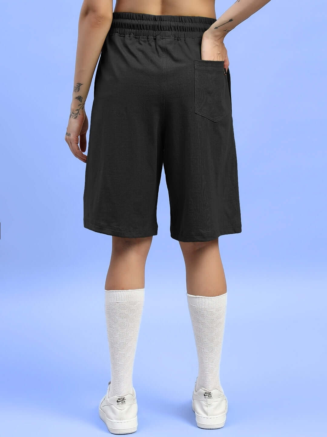 Back view of model wearing WOMENS WIDELINE SUMMER CO-ORD SET BLACK shorts with pockets, showcasing relaxed fit and lightweight cotton fabric.