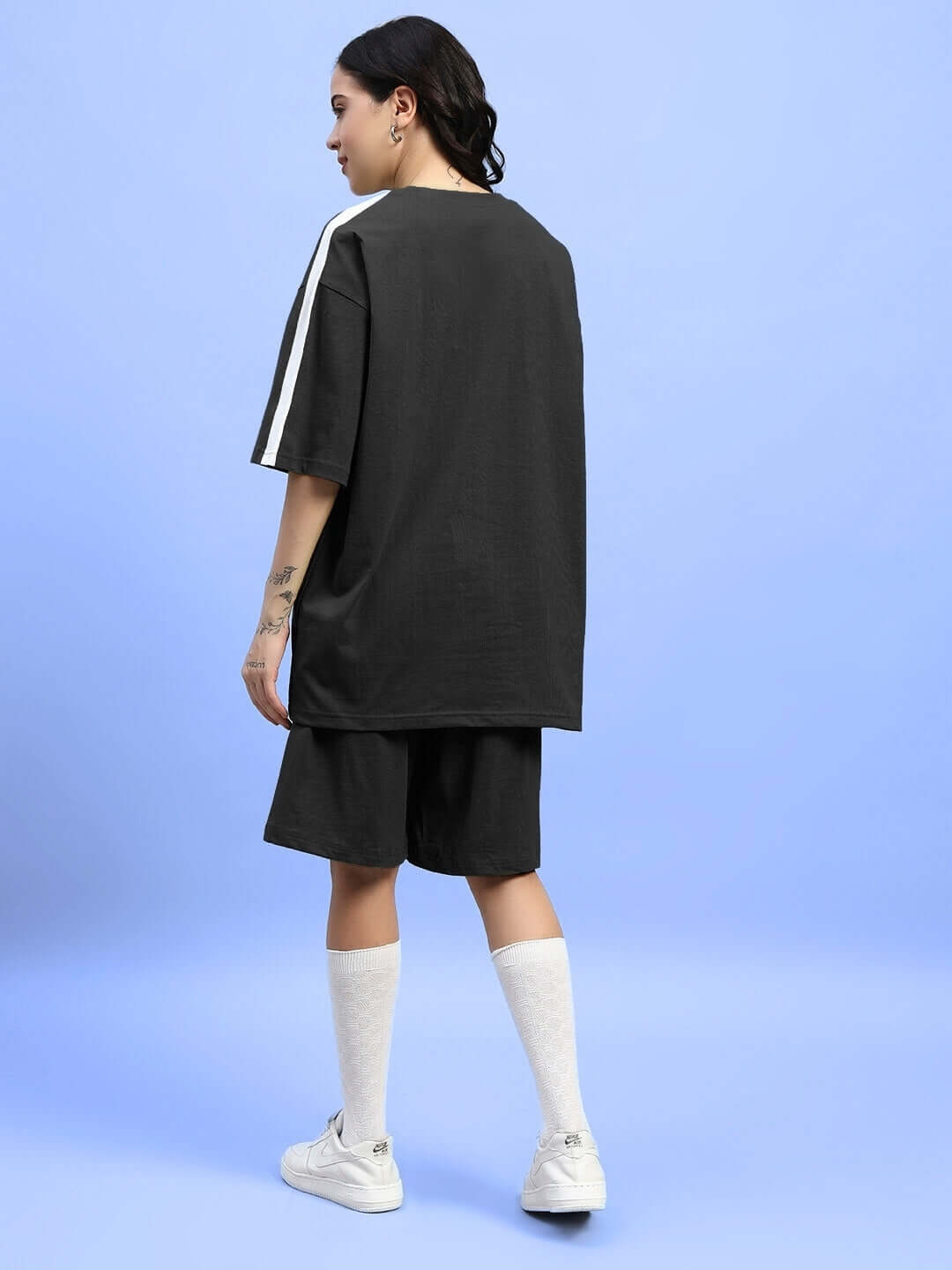 Back view of a woman wearing the WOMENS WIDELINE SUMMER CO-ORD SET BLACK in lightweight premium cotton.