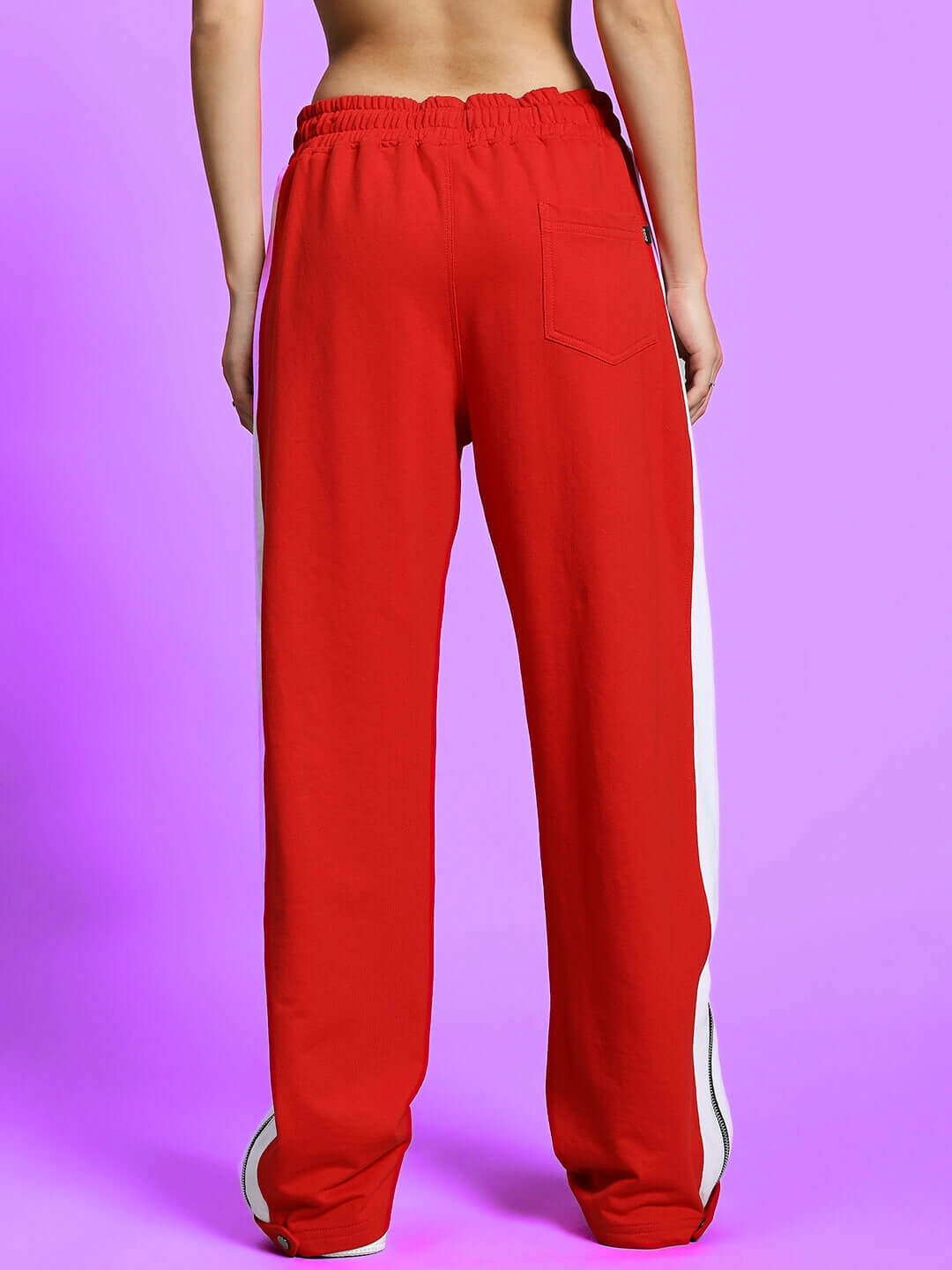 Back view of women's red and white slit zipper joggers from DUDS, featuring an elastic waistband and sleek design.