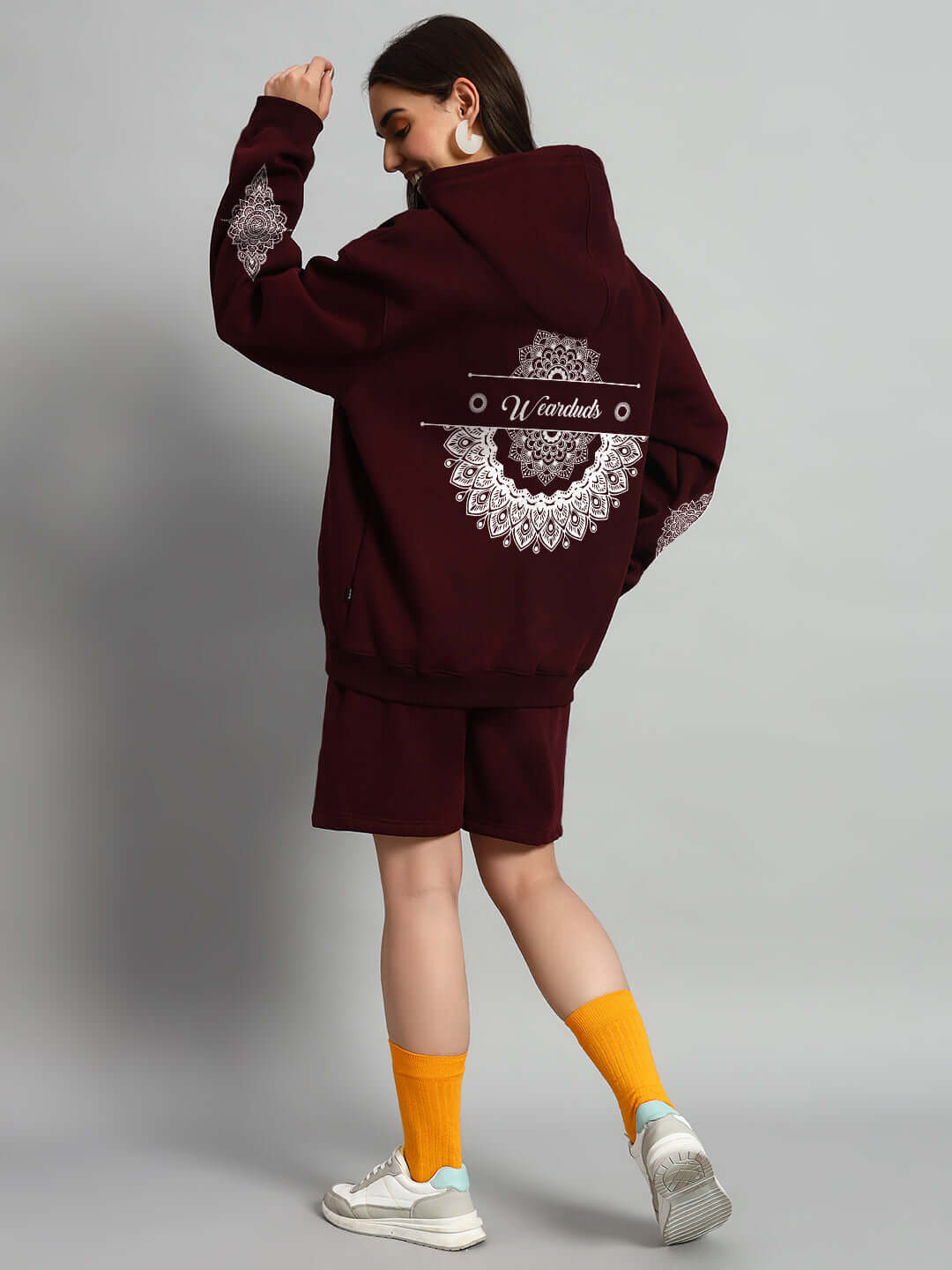 Back view of model wearing WOMEN'S YANTRA FLEECE SHORTS WINE with intricate designs, showcasing style and comfort in casual apparel.